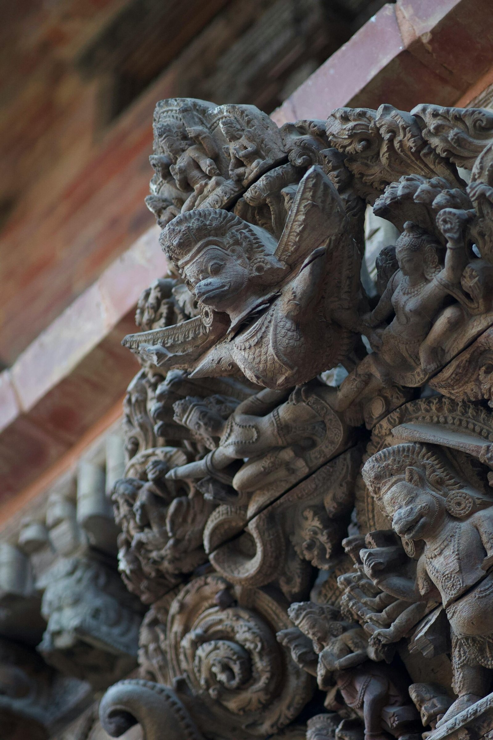 Close-up of detailed stone carvings at a temple in Lalitpur, Nepal, showcasing traditional Nepali artistry.