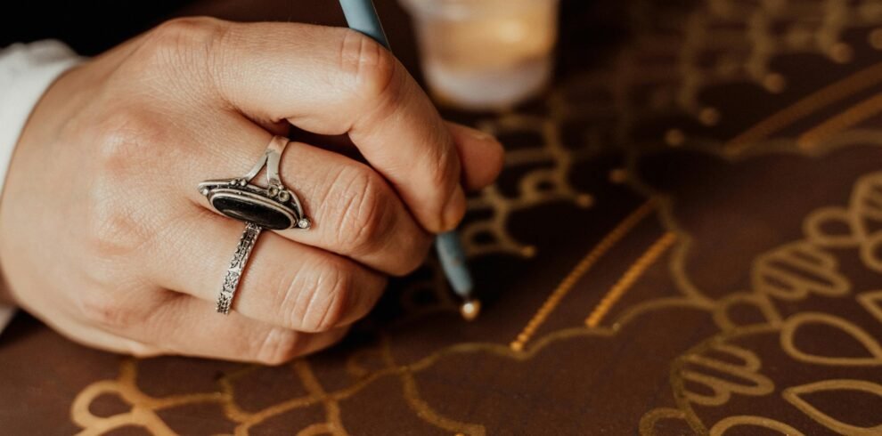 Close-up of a hand creating intricate dot painting art in Erfurt, capturing details and creativity.